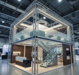 Two-level wood and steel exhibition stand with open staircase