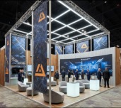 Purple and orange lit geometric exhibition booth structure