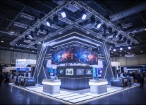 Orange-lit truss stage exhibition booth with LED screens