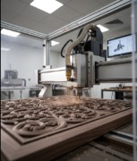 CNC router machine cutting a wood exhibition stand component