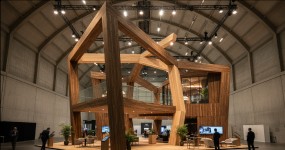 Angular geometric wood exhibition structure inside a large exhibition hall
