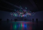 Colourful illuminated light installation in a dark exhibition space